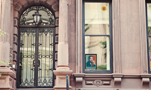 NYC brownstone with mayor candidate signs in window