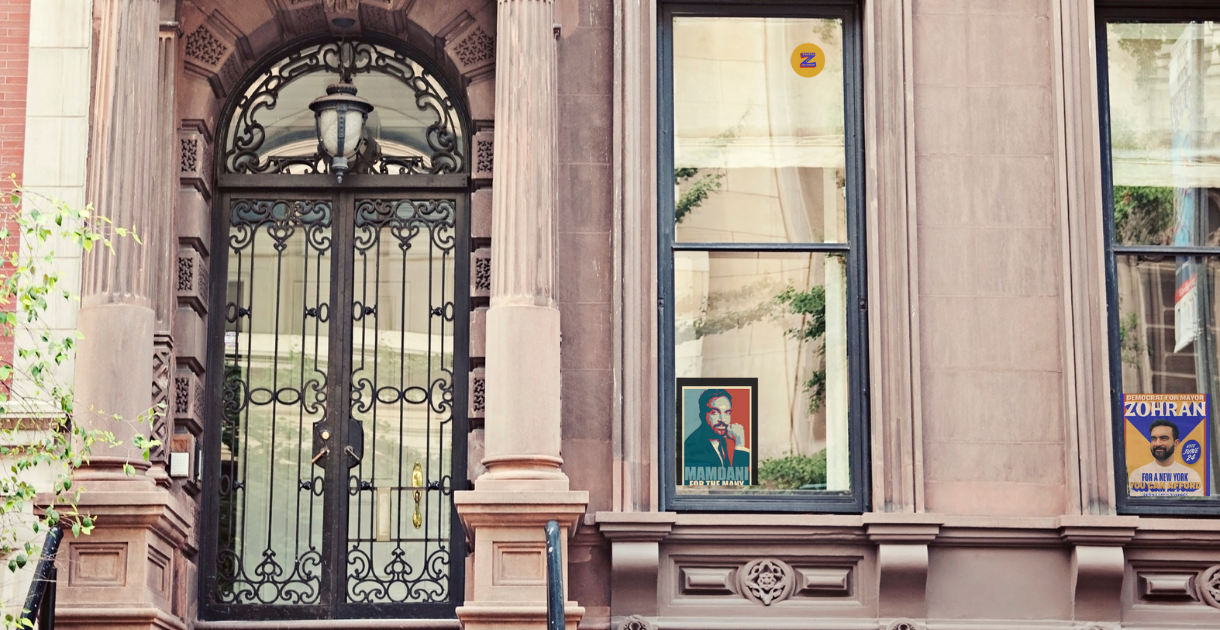 NYC brownstone with mayor candidate signs in window